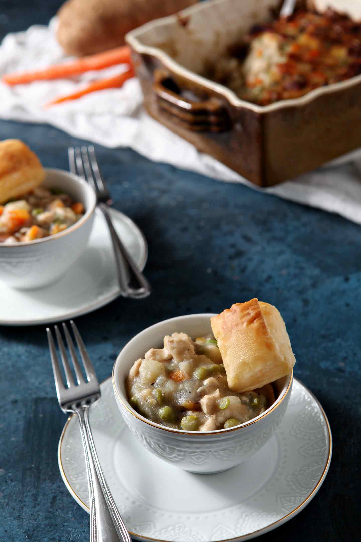 chicken pot pie in a white bowl with a fork