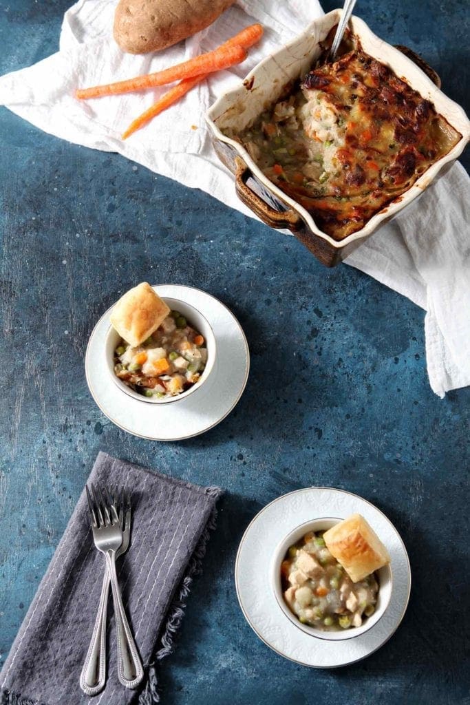 chicken pot pie on a dark blue surface with forks