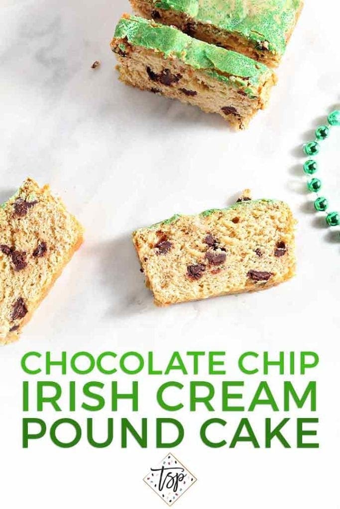 Several slices of a chocolate chip loaf cake sit on a marble surface next to a green set of beads with the text 'chocolate chip irish cream pound cake'