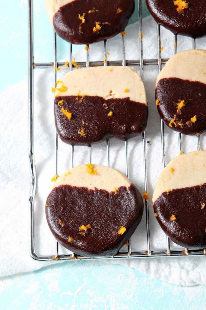 Chocolate-coated shortbread cookies on a cooling rack