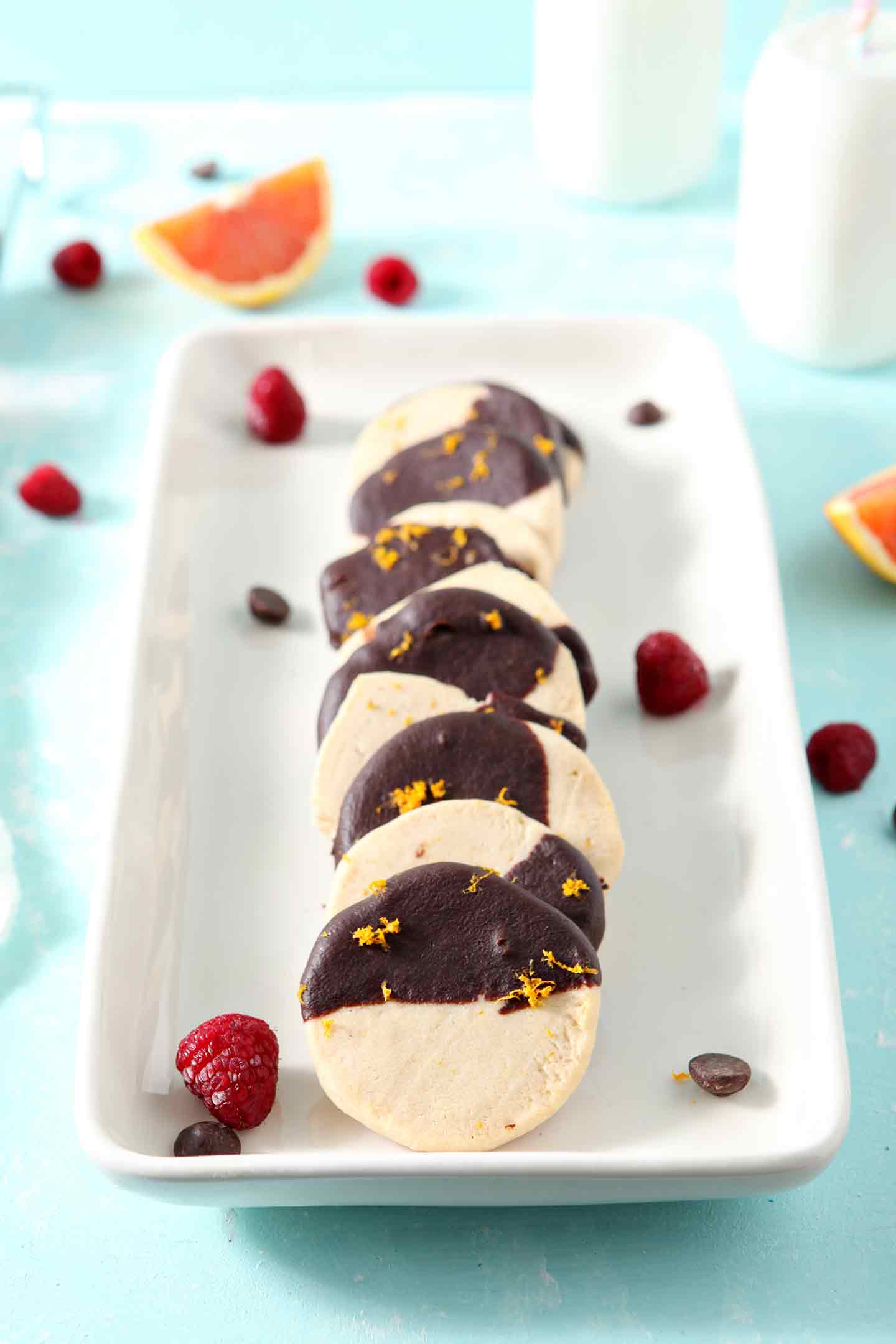 Orange Raspberry Shortbread Cookies lined up on a white platter for serving