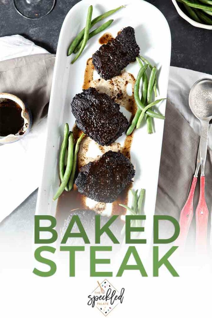 Overhead of Baked Steak on a platter with green beans and Pinterest text