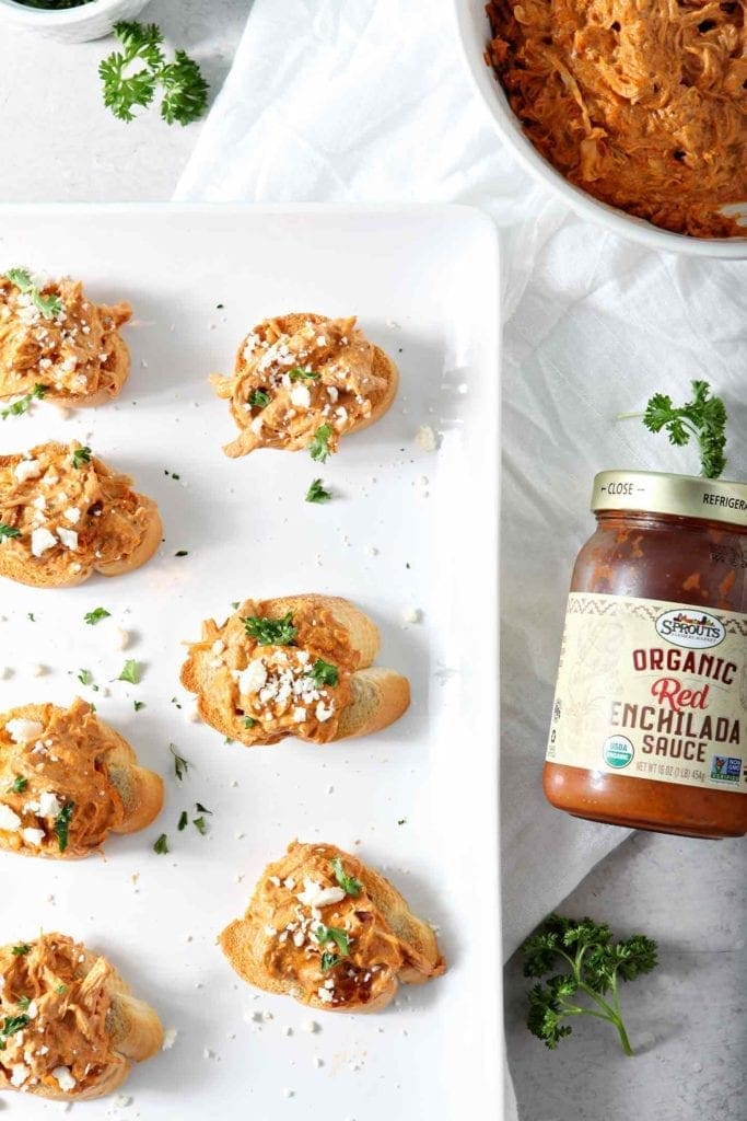 Chicken Enchilada Bruschetta lined up on a white platter before serving