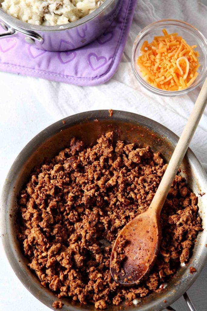 Cooked Chorizo from above on a white background with other ingredients for Mashed Potato Chorizo Breakfast Tacos