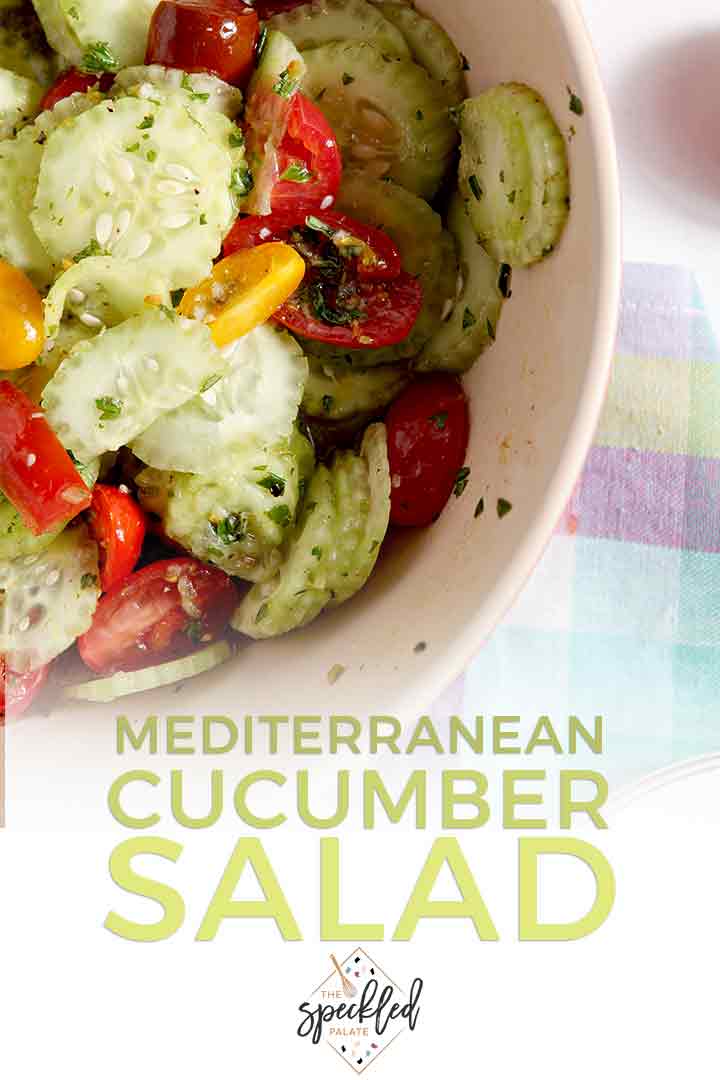 Close up of a bowl holding Mediterranean Cucumber Salad with Heirloom Tomatoes and Lemon Vinaigrette, with Pinterest text