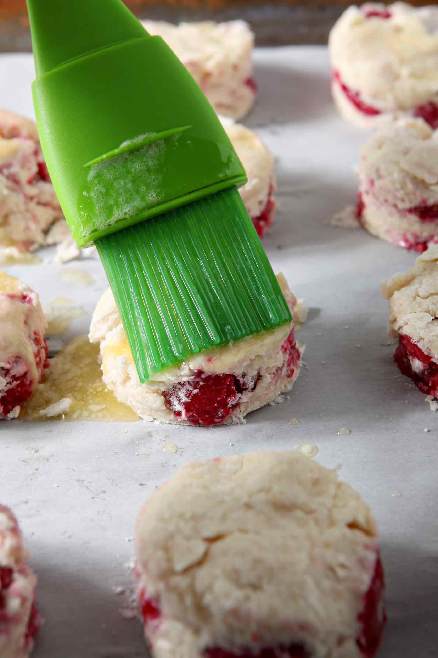 Raspberry Shortcake Biscuits are brushed with butter and sprinkled with turbinado sugar before baking.