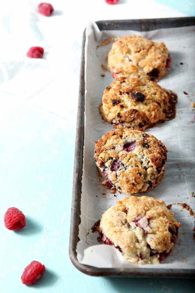 Raspberry Shortcake Biscuits, fresh out of the oven, on a parchment paper-lined baking sheet.