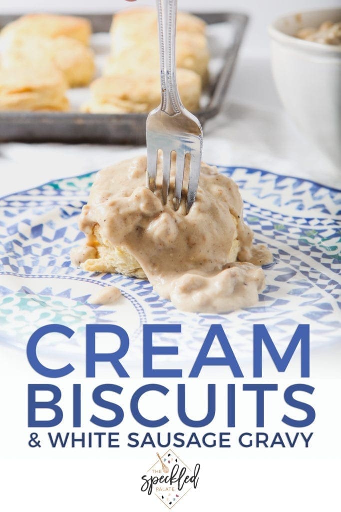 A fork cuts into a Cream Biscuit, topped with White Sausage Gravy, with Pinterest text