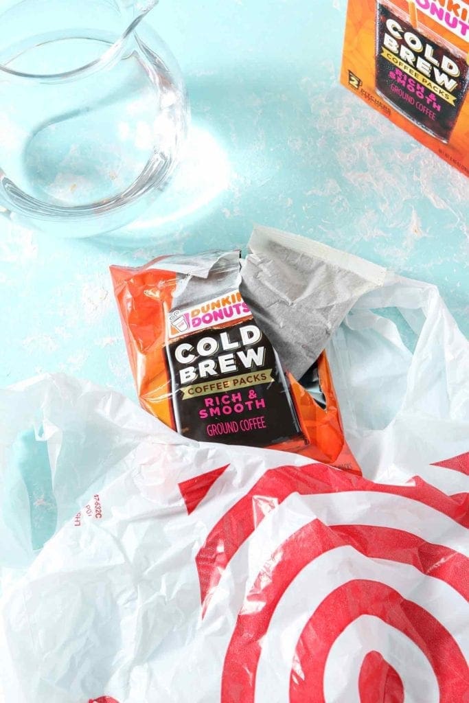 Dunkin' Donuts Cold Brew coffee pack sticking out of a plastic Target bag, ready for brewing