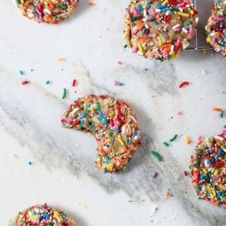 Overhead image of Funfetti Cookies, including one bitten into cookie.