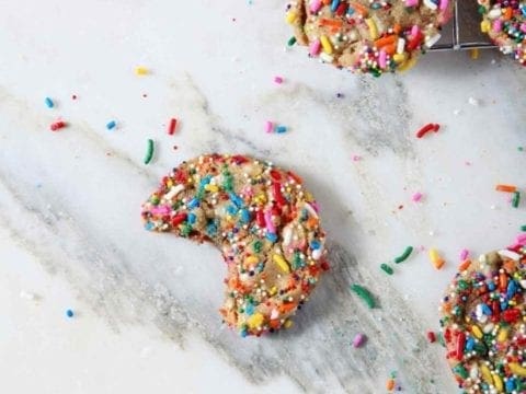 Overhead image of Funfetti Cookies, including one bitten into cookie.