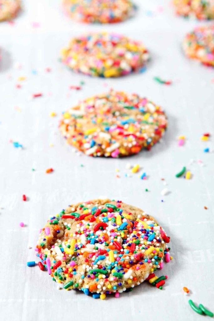 Just baked Funfetti Cookies sit on a sheet pan after coming out of the oven.