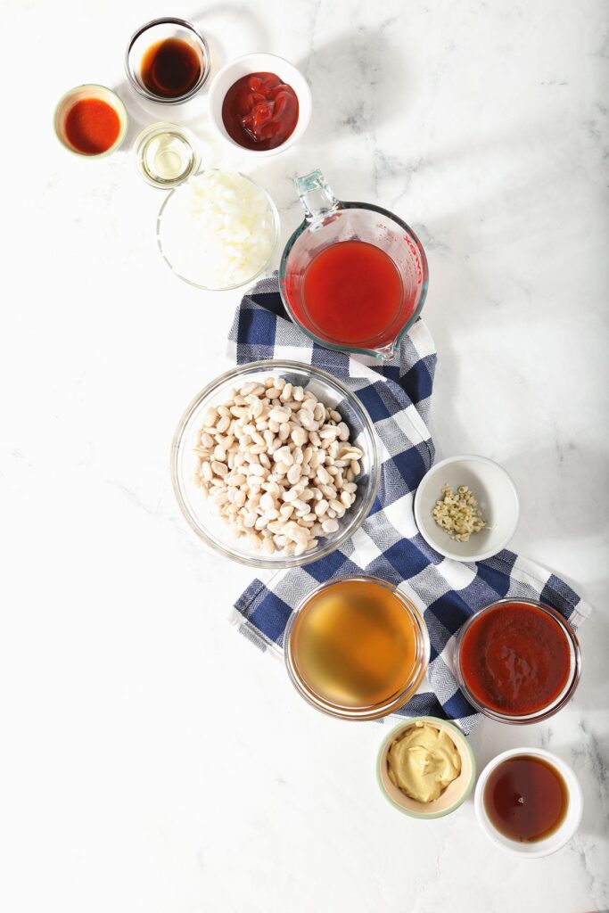 White beans with other ingredients in bowls on marble