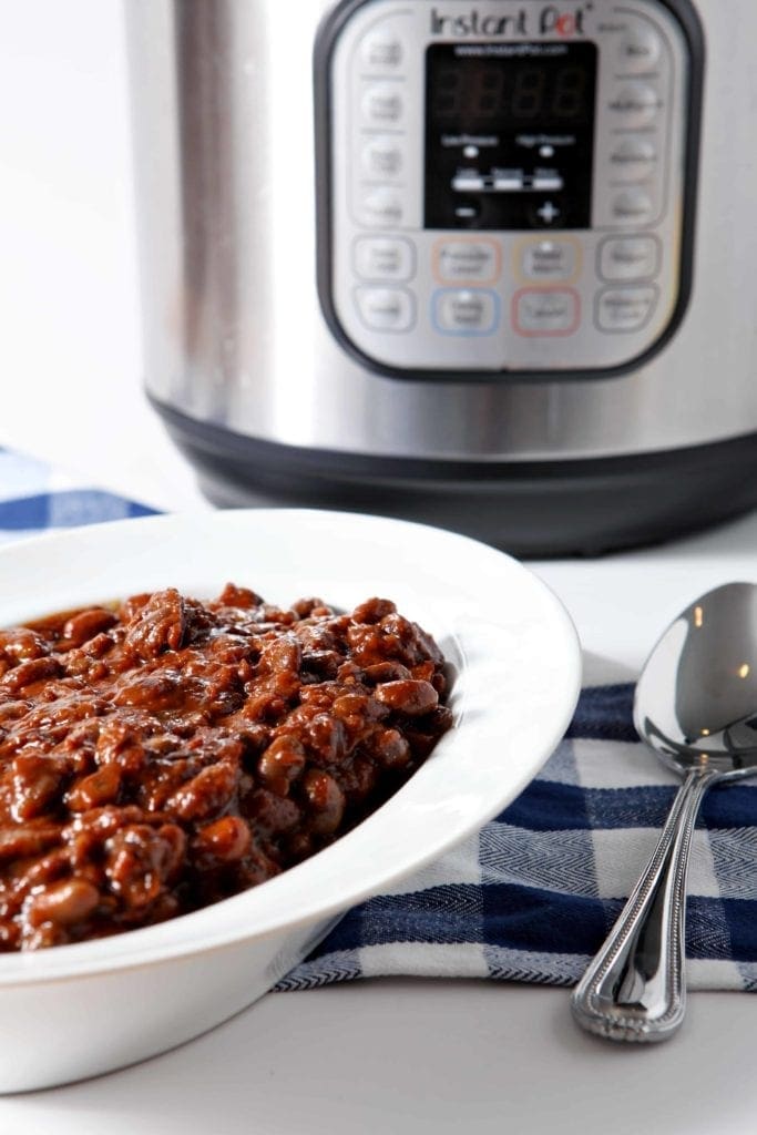 Vegetarian Baked Beans are served in a white bowl in front of an Instant Pot