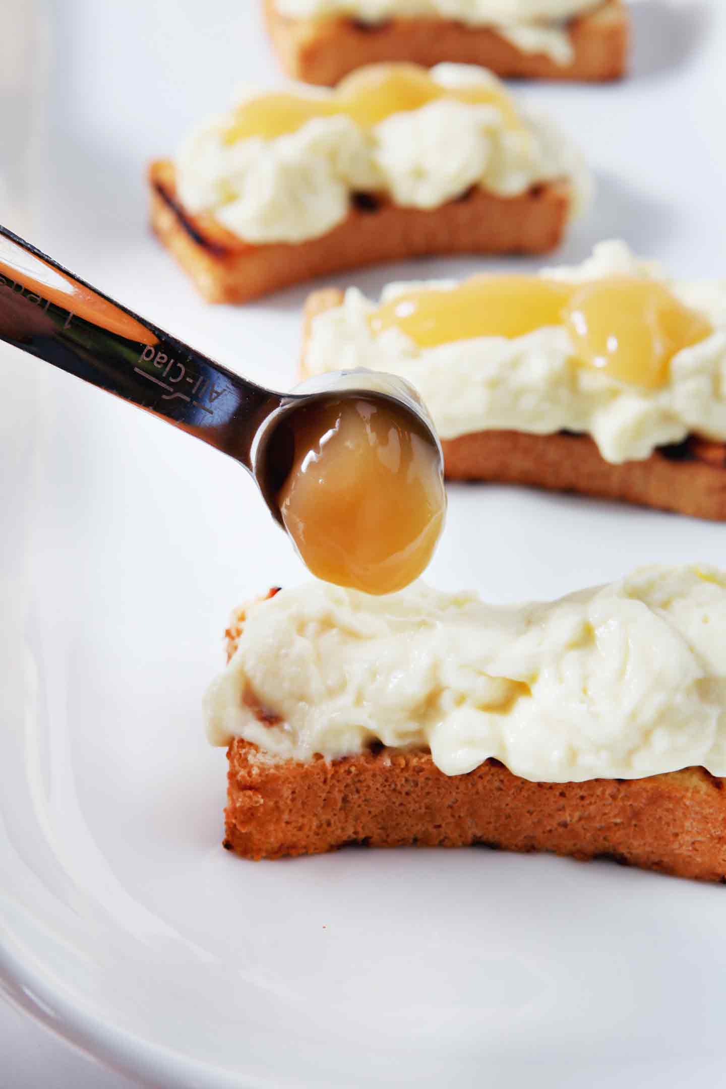 Lemon curd is drizzled on top of the pudding for the Patriotic Strawberry Bruschetta.