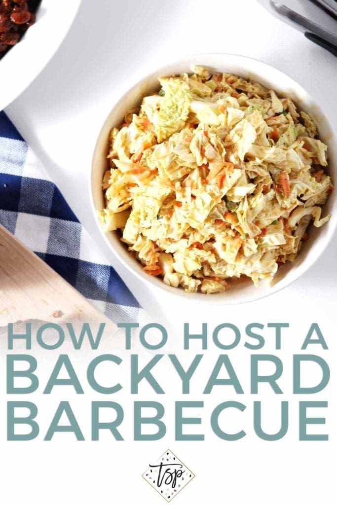 A bowl of honey mustard coleslaw on a blue checked towel, from above, with the text "how to host a backyard barbecue"