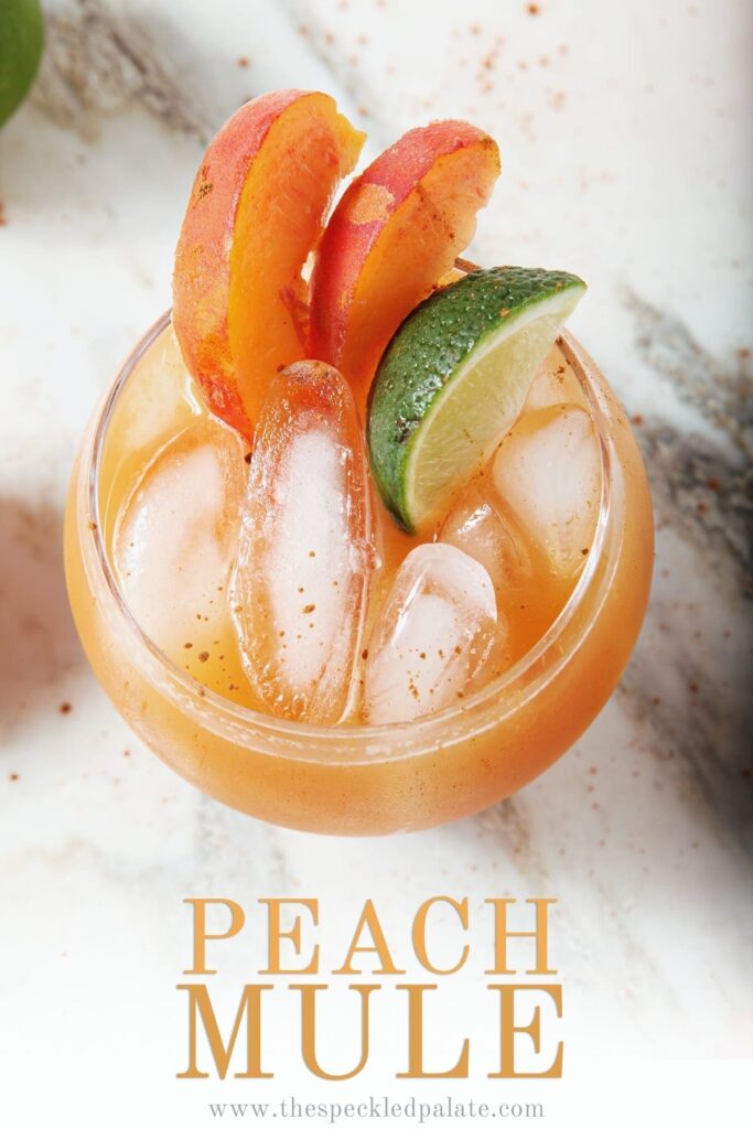 Closeup overhead image of a singular Peach Moscow Mule, with Pinterest text