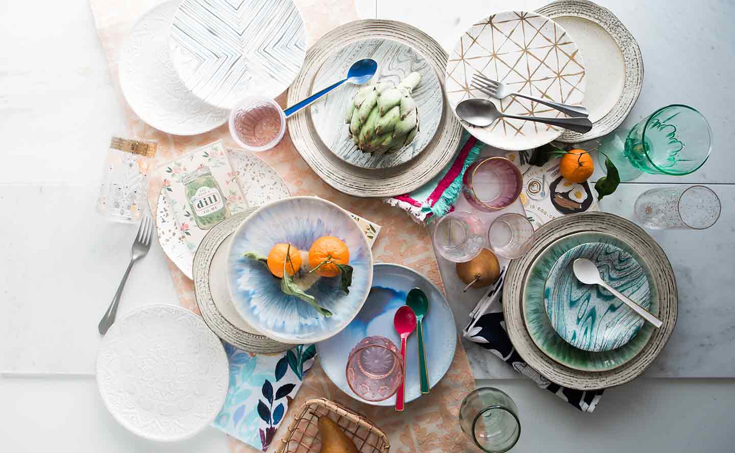 Various dishes and foods are laid out flat on a table