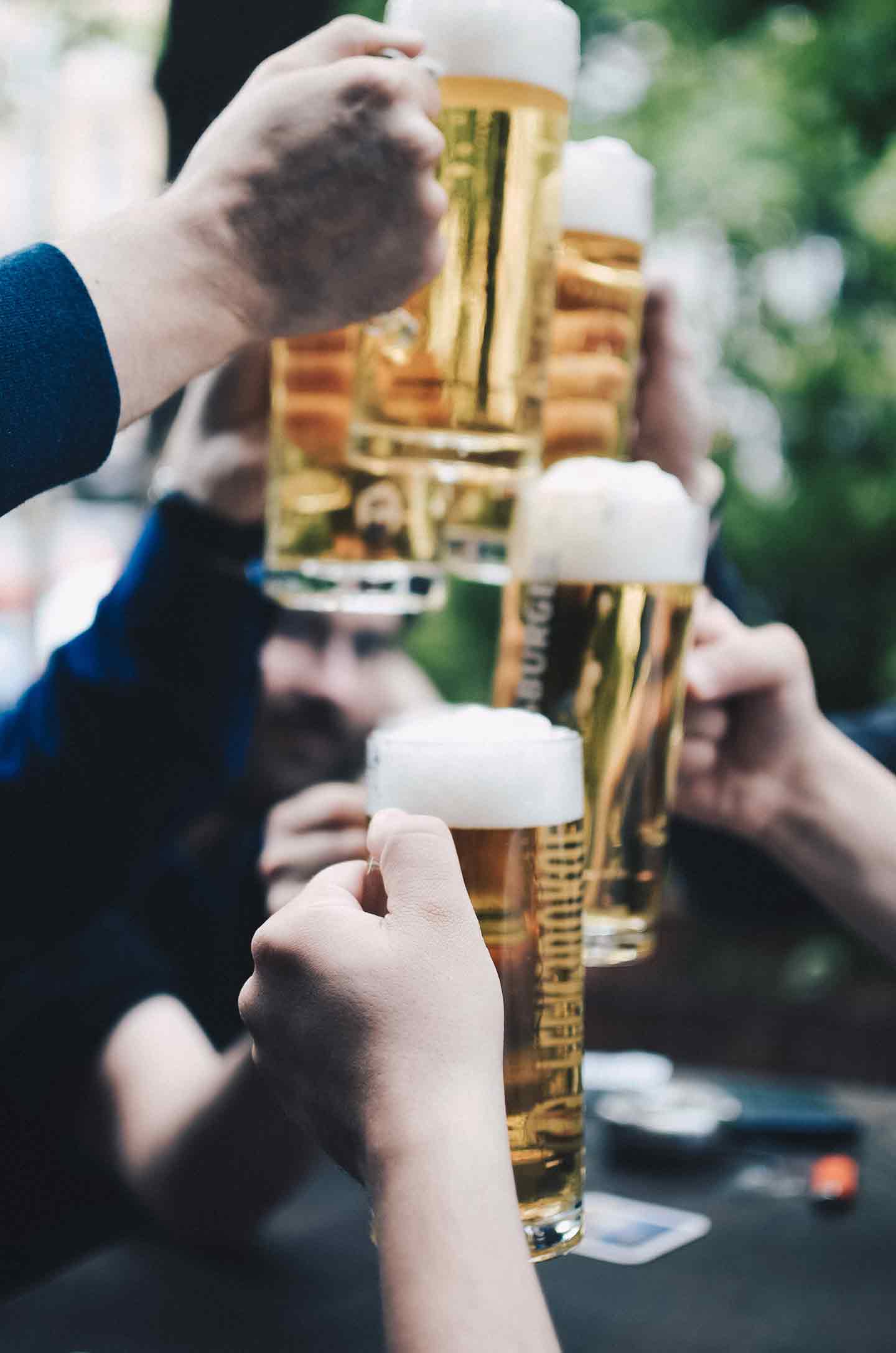 People clink their beer glasses together