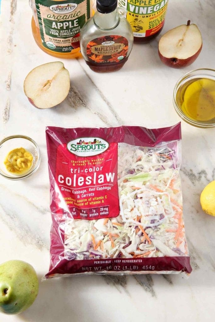 Ingredients for the Pear Slaw are laid out on a marble background