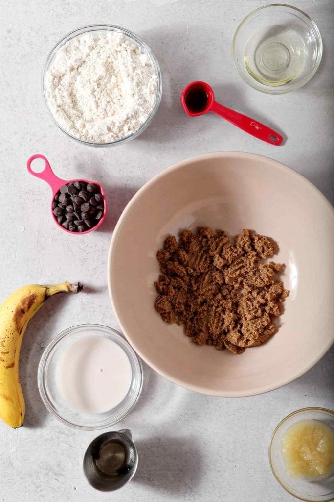 Ingredients for Vegan Banana Chocolate Chip Muffins are laid out before the batter is mixed