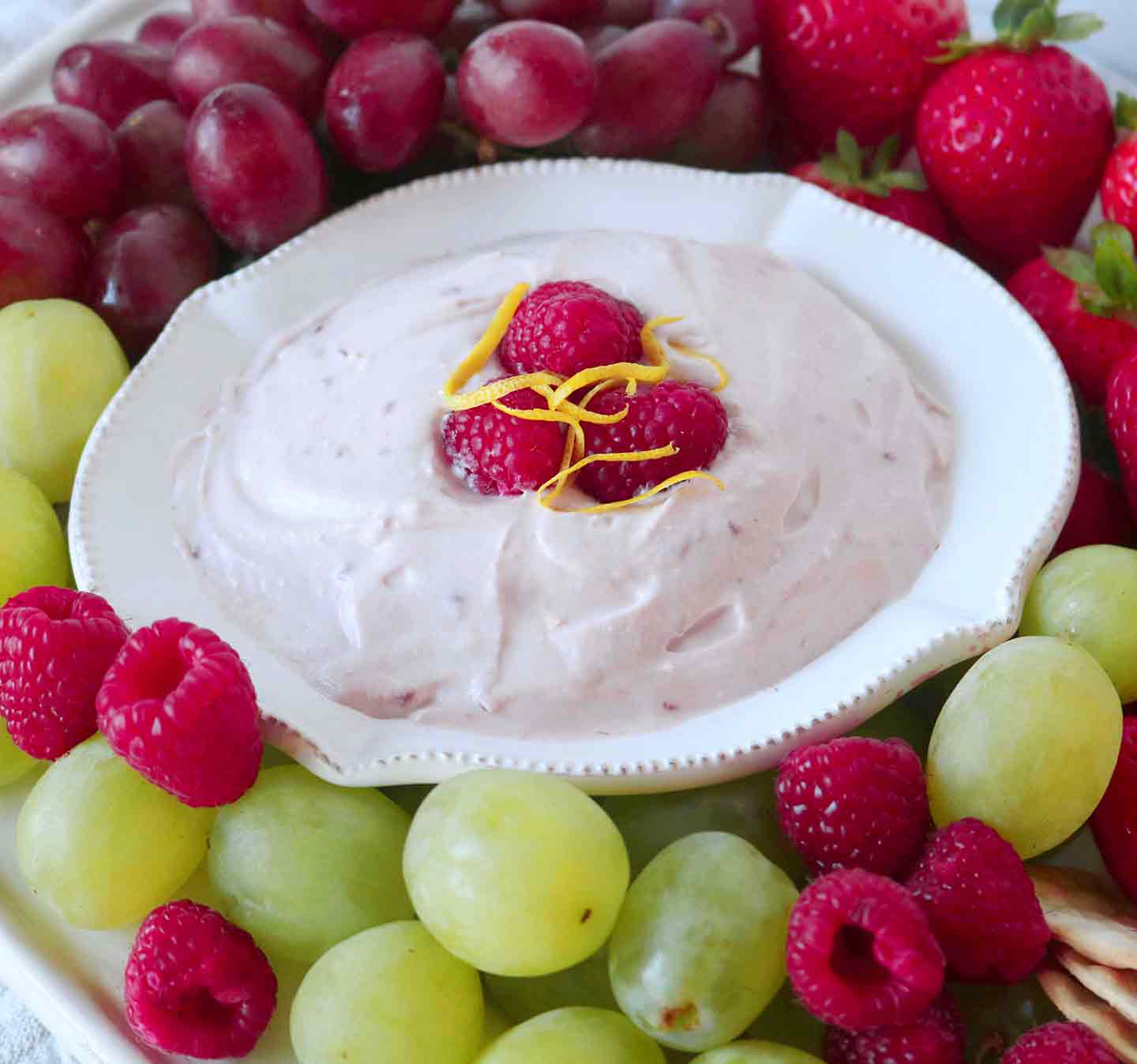 Raspberry Yogurt Fruit Dip is served with fresh raspberries, green and red grapes