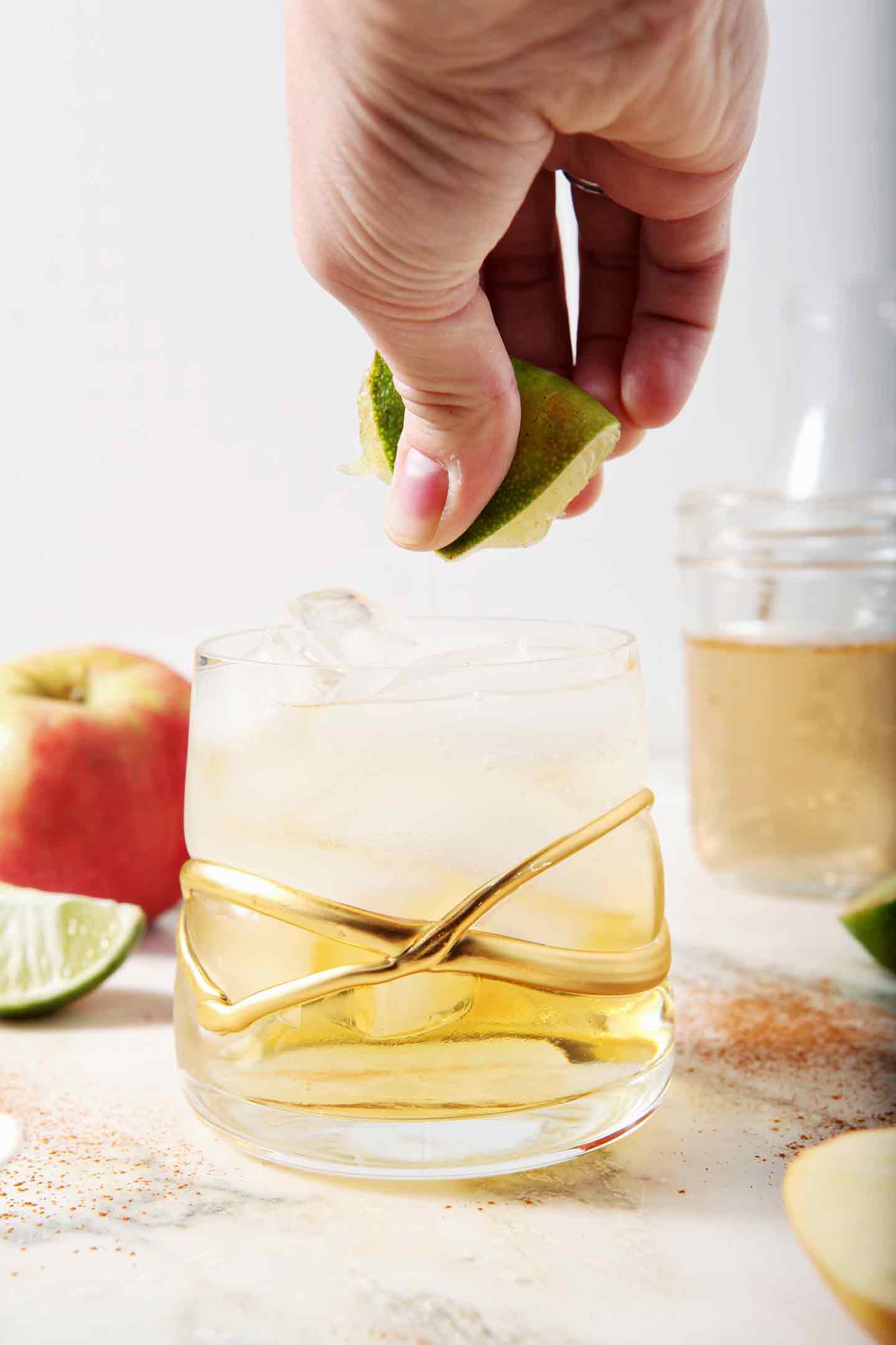 A lime is squeezed into a newly mixed Apple Cider Mule