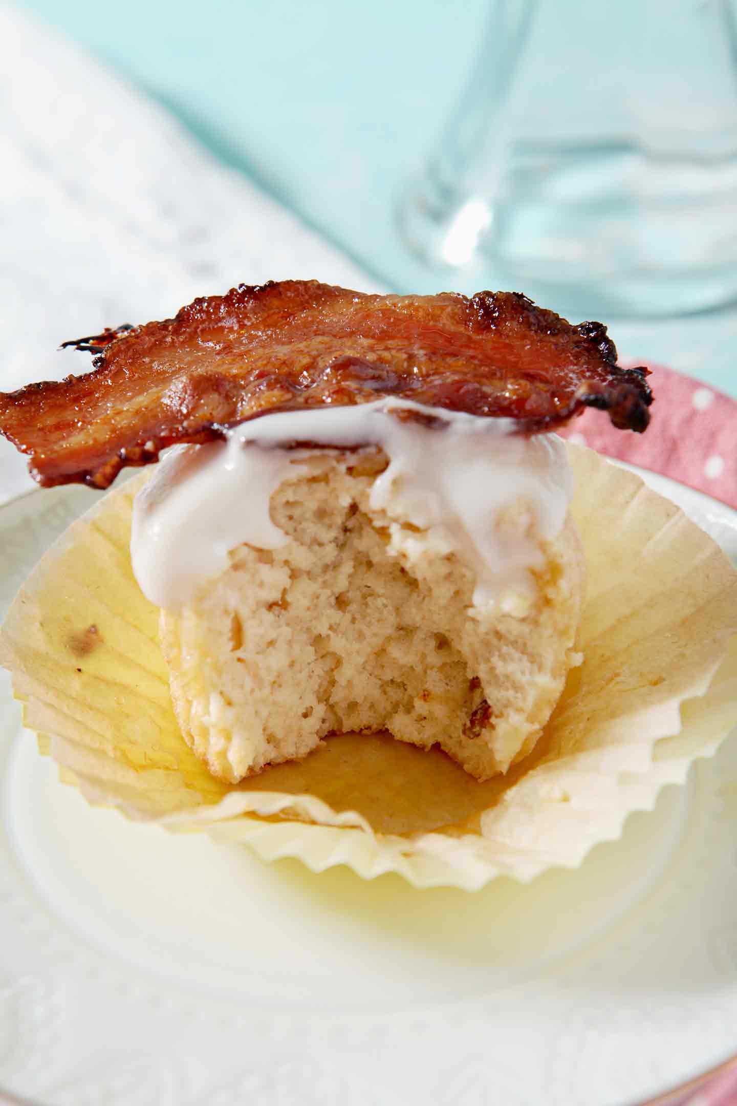 Close-up image of a Bourbon Maple Bacon Cupcake that has a bite taken out of it