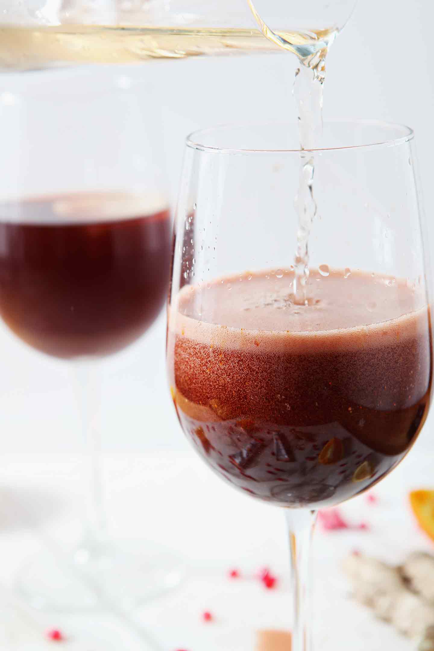 Ginger ale is poured on top of the rest of the drink ingredients to make a Pomegranate Ginger Orange Sparkling Mocktail