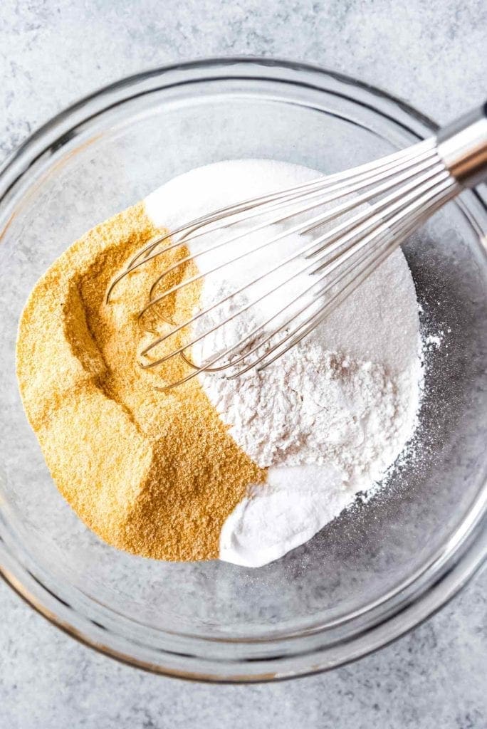 Dry ingredients are shown in a bowl with a whisk