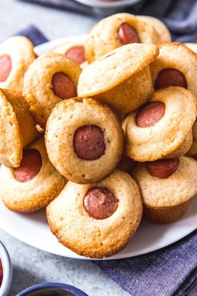 Close up of stacked Mini Corn Dog Muffins on a plate