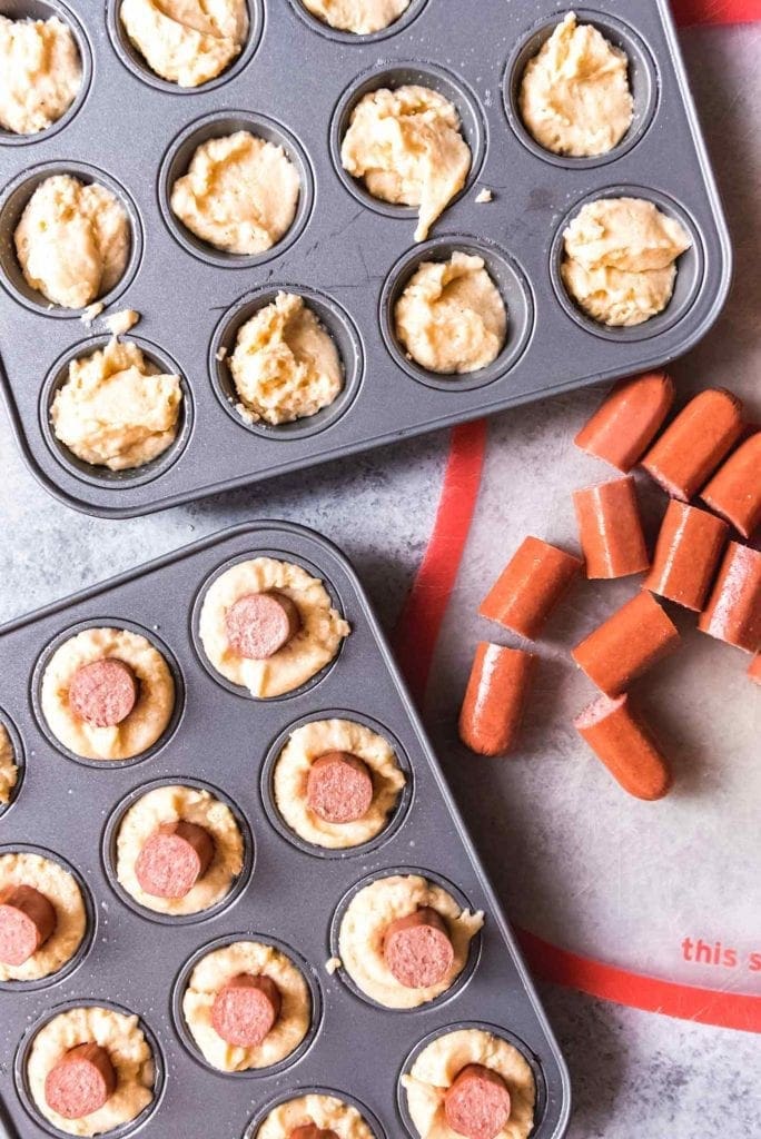 Mini corndog muffins in their tins before baking