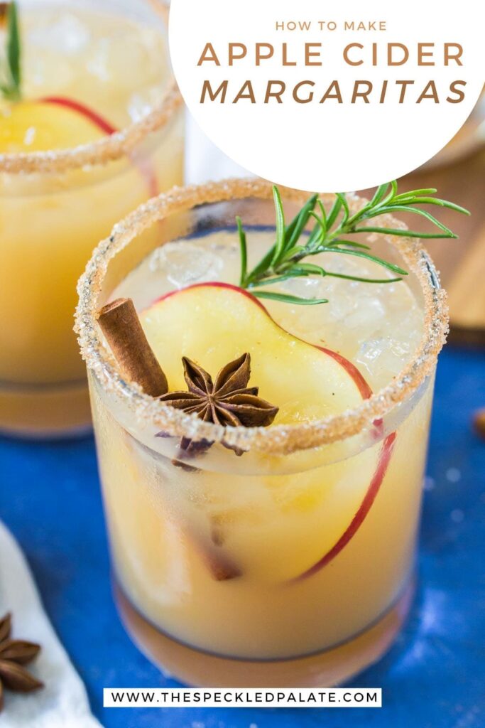 Close up of an Apple Cider Margarita garnished with an apple slice, star anise, cinnamon stick and rosemary with the text 'how to make apple cider margaritas'