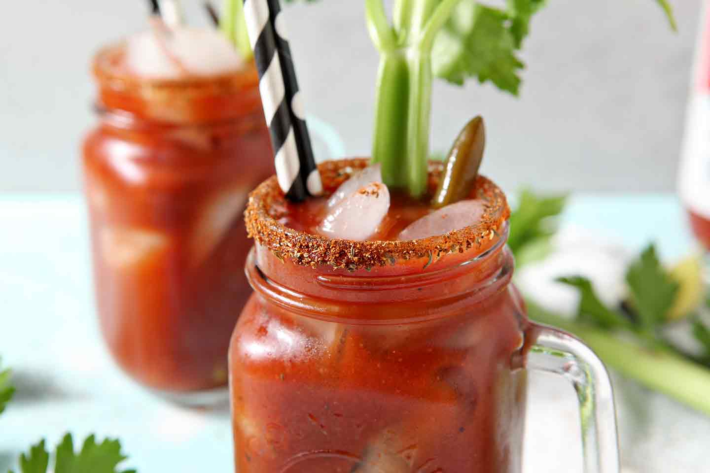 Two BBQ Bloody Marys sit next to each other on a light background