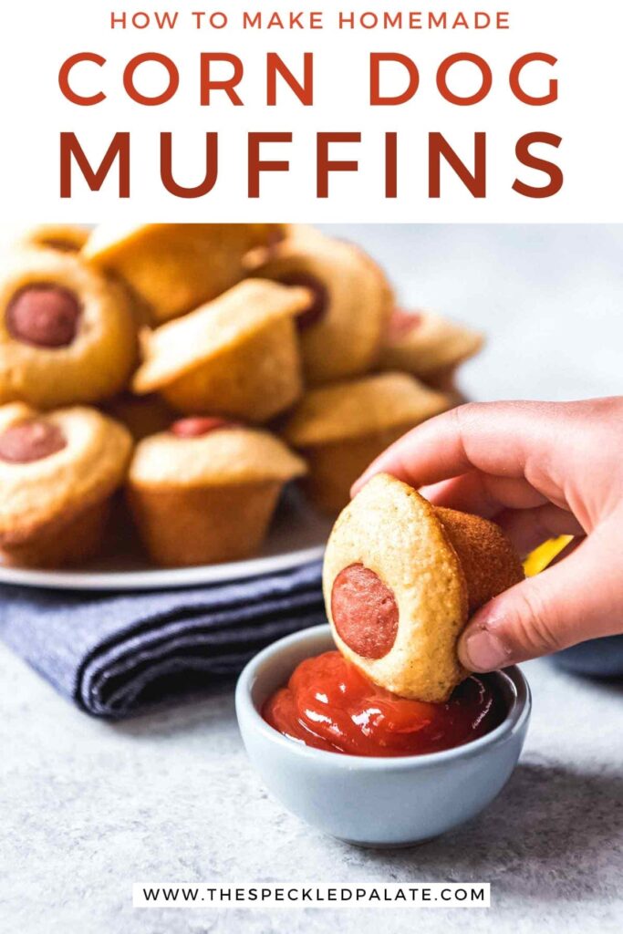 A Mini Corn Dog Muffin is dipped into a bowl of ketchup in front of a plate of more mini muffins with the text 'how to make homemade corn dog muffins'