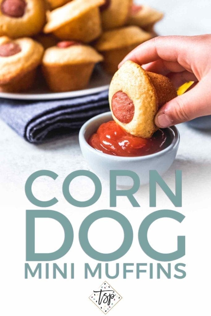 Pinterest photo for Corn Dog Mini Muffins, featuring text and a person dipping a mini muffin into a bowl of ketchup