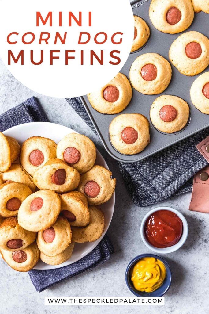 Overhead of a plate of Mini Corn Dog Muffins and a muffin tin holding more next to bowls of ketchup and mustard with the text 'mini corn dog muffins'