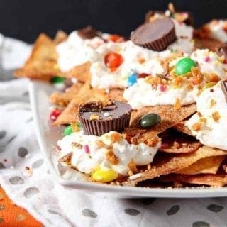 Horizontal image of a platter of Halloween Dessert Nachos, featuring several types of Halloween candy