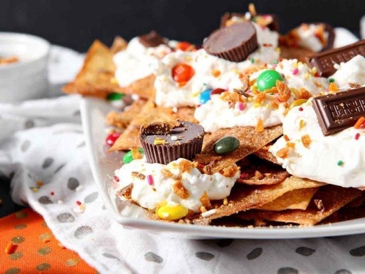 Horizontal image of a platter of Halloween Dessert Nachos, featuring several types of Halloween candy