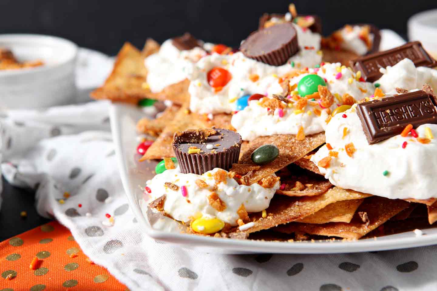 Horizontal image of a platter of Halloween Dessert Nachos, featuring several types of Halloween candy