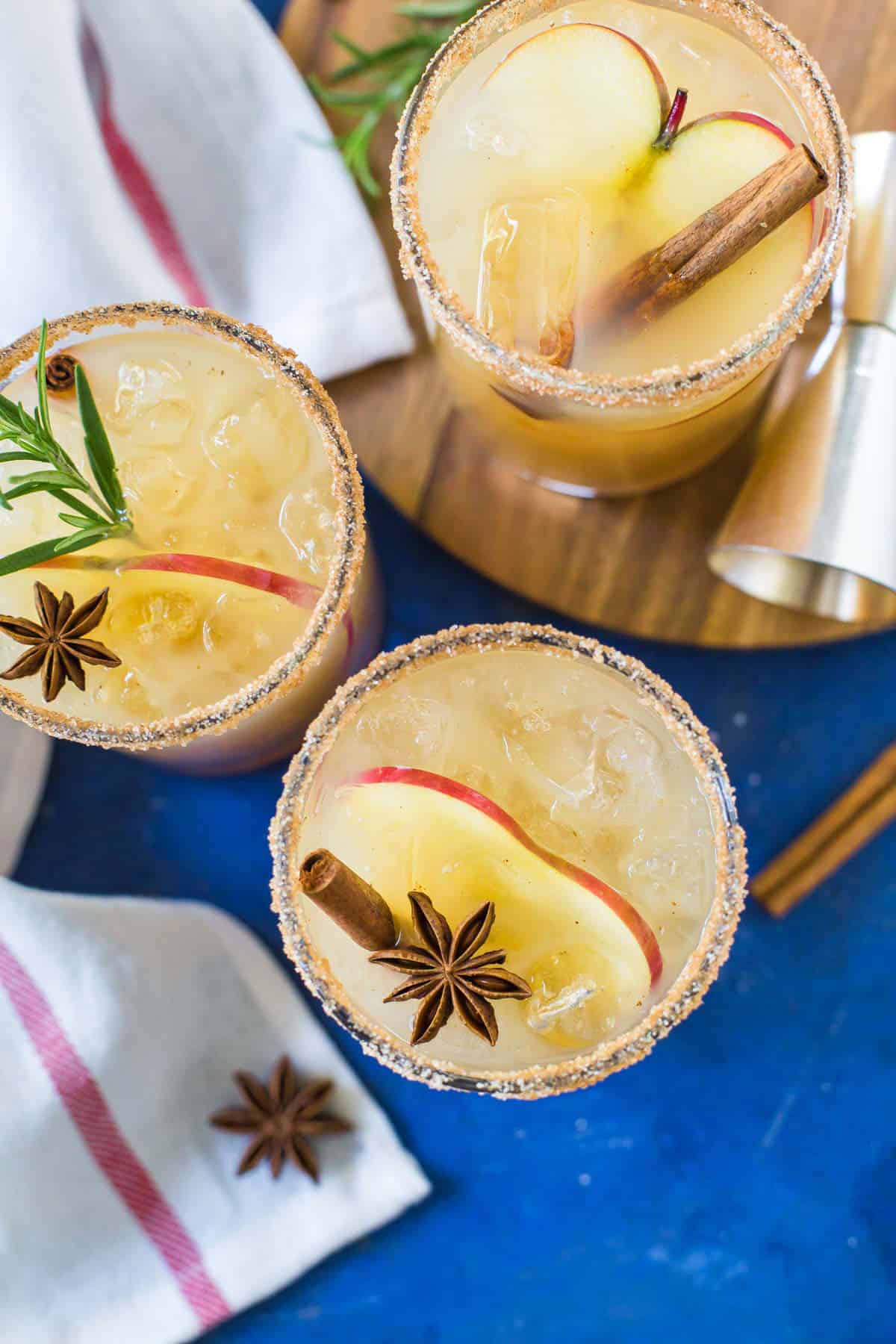 Overhead image of Apple Cider Margaritas on a blue background