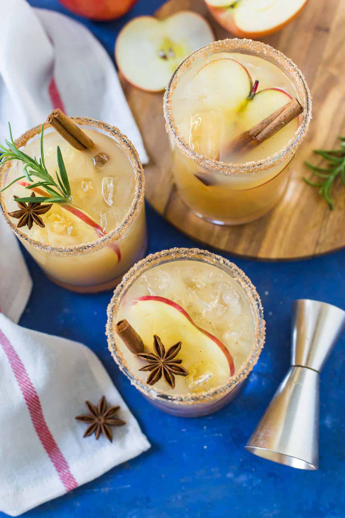 Overhead image of Apple Cider Margaritas on a blue background