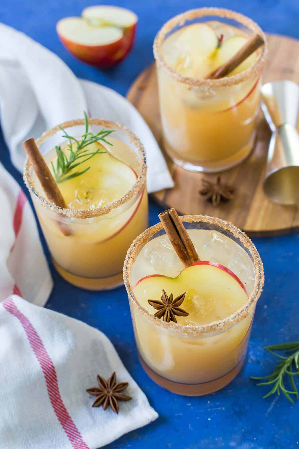 Three Apple Cider Margaritas sit on a blue background