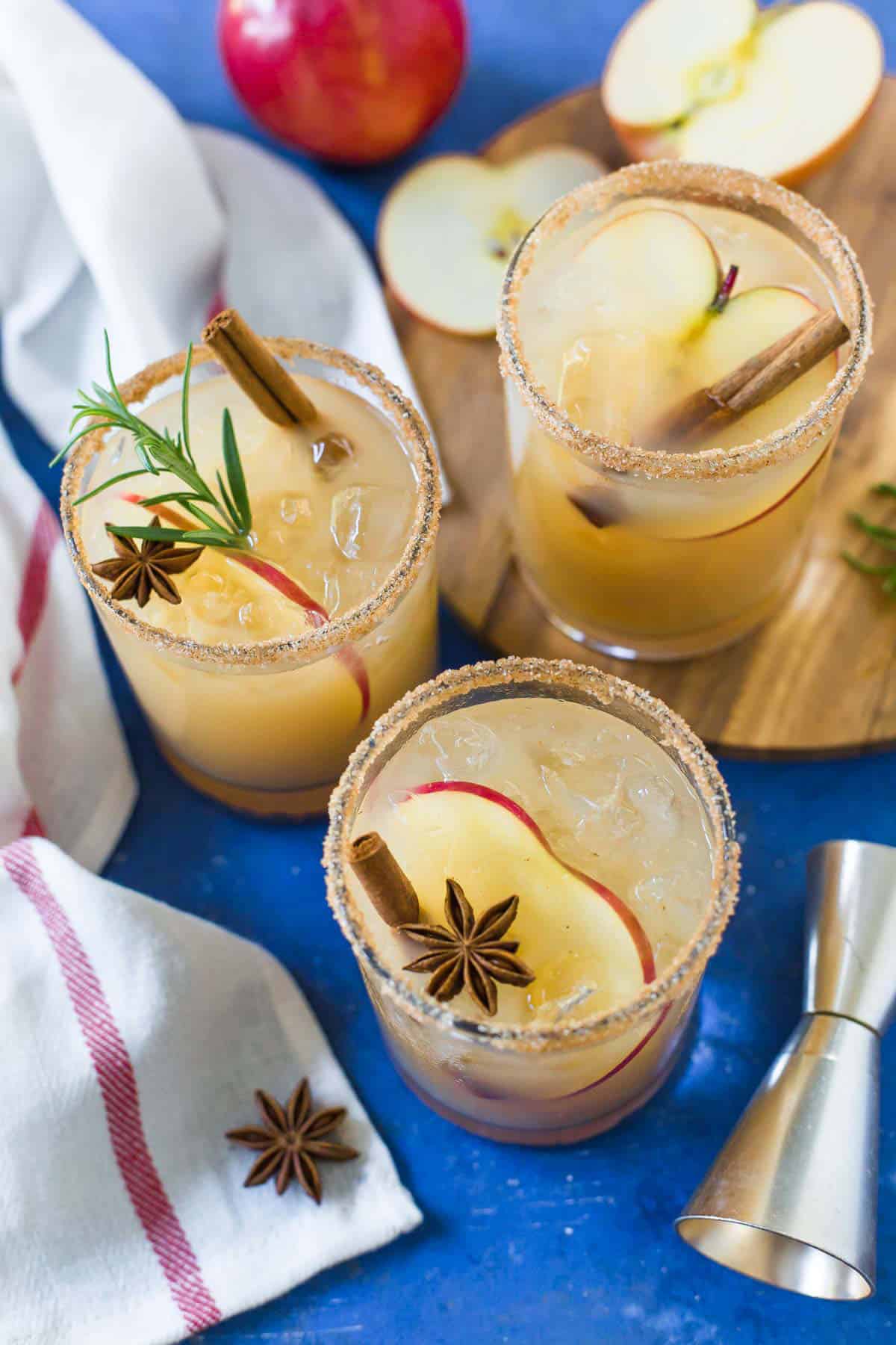 Overhead image of Apple Cider Margaritas on a blue background