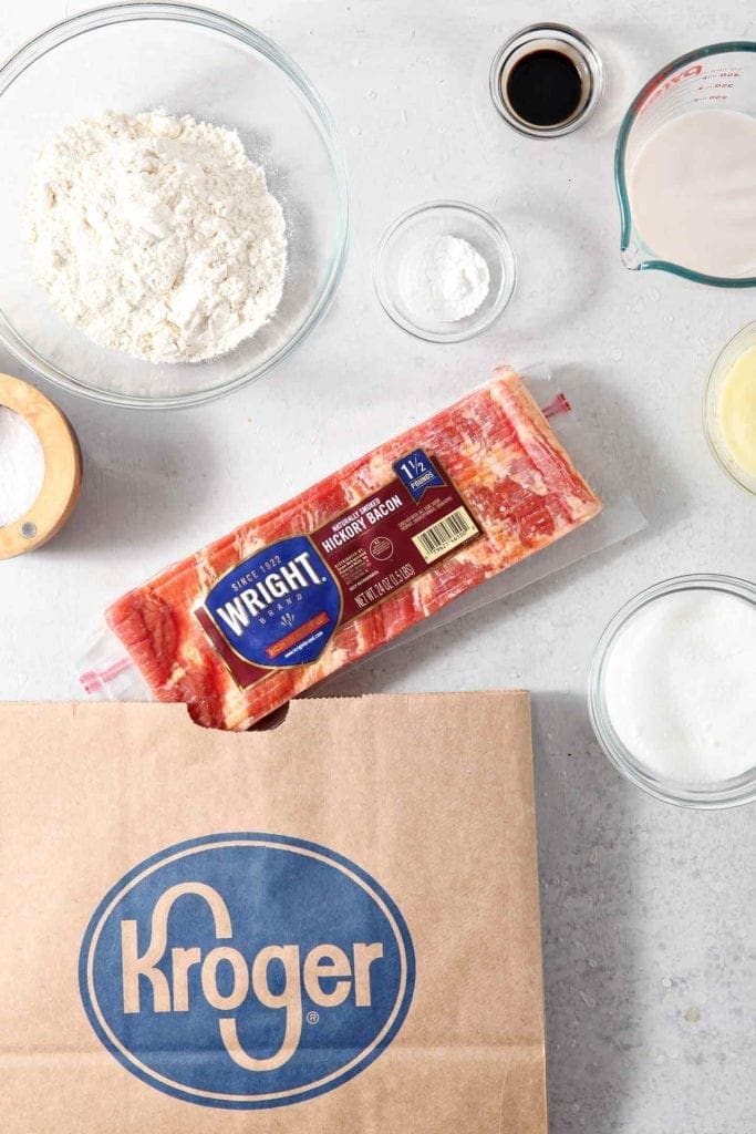 Ingredients for Maple Bacon Donuts are shown on a grey countertop