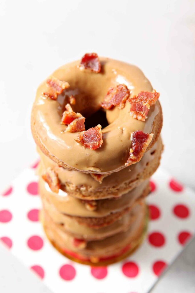 Stacked glazed baked donuts on a red polka dot napkin