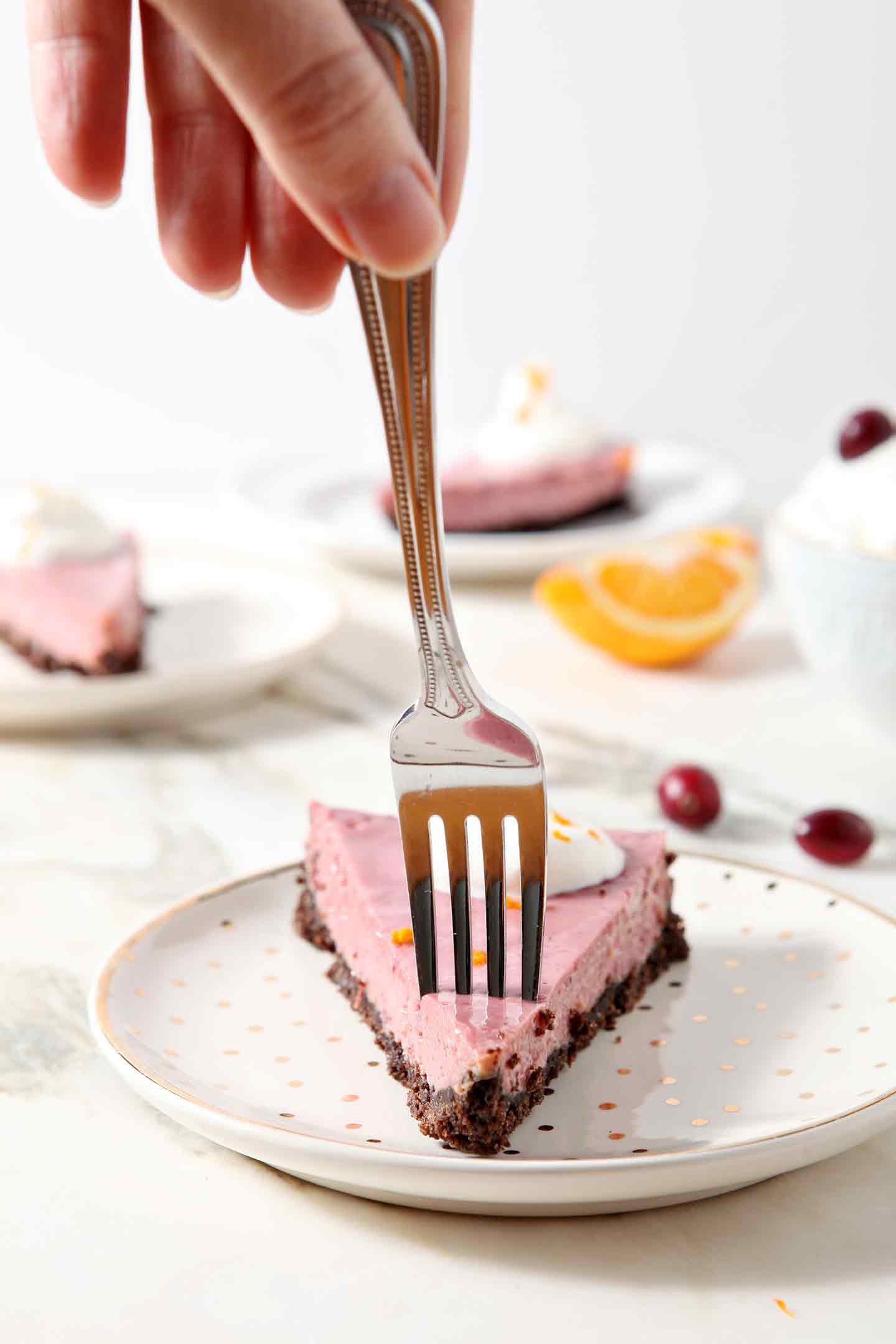 A fork cuts into a slice of Creamy Cranberry Tart