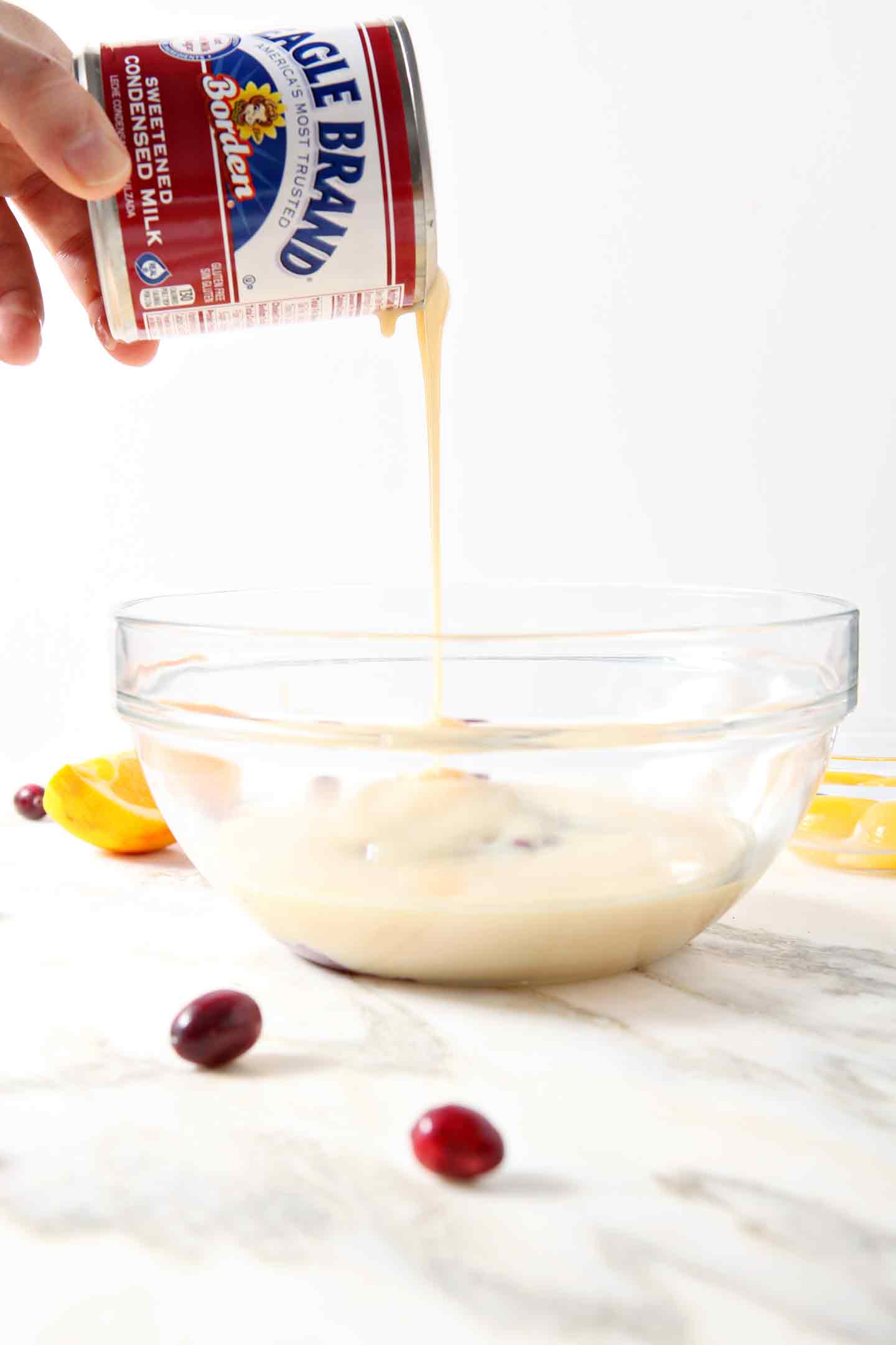 Eagle Brand Sweetened Condensed Milk is poured into a bowl to create the filling for the Creamy Cranberry Tart