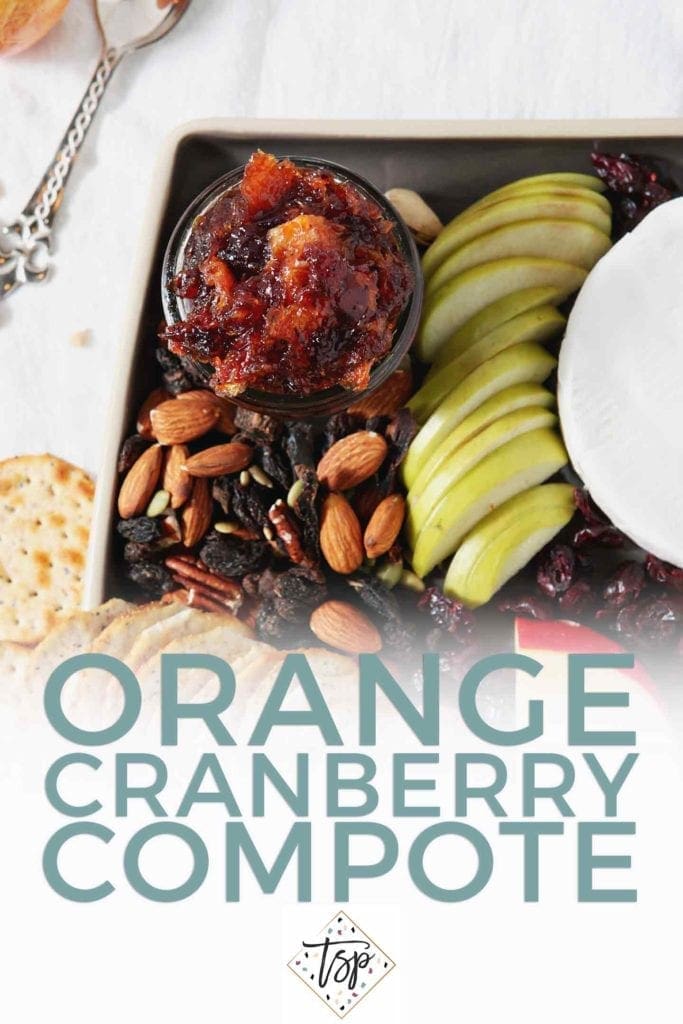 Pinterest image of Orange Cranberry Compote, shown from above on a cheese board with Pinterest text