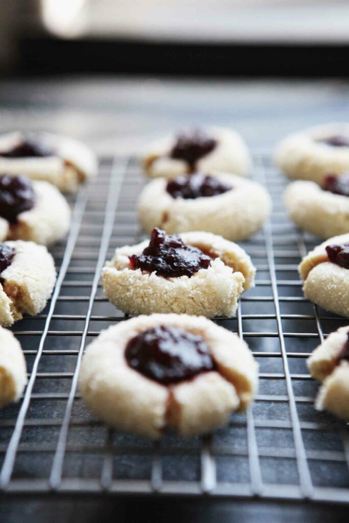 Orange Cranberry Cream Cheese Thumbprint Cookies cool on a wire rack by the window